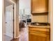 Open-concept kitchen with wooden cabinets, flowing into a living area with a fireplace at 9470 Loggia St # D, Highlands Ranch, CO 80126
