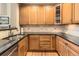 Well-appointed kitchen featuring granite countertops, stainless steel sink, and beautiful wood cabinetry at 9470 Loggia St # D, Highlands Ranch, CO 80126