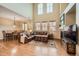 Open concept living space with hardwood floors, fireplace, and large windows with great lighting at 9470 Loggia St # D, Highlands Ranch, CO 80126