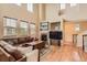 Spacious living room with high ceilings, hardwood floors, fireplace and plenty of natural light at 9470 Loggia St # D, Highlands Ranch, CO 80126