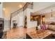 Bright living room with hardwood floors, staircase and seamless access to a cozy dining area at 9470 Loggia St # D, Highlands Ranch, CO 80126