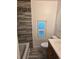 Bathroom featuring tiled shower, updated toilet, vanity, and natural light, combining style and function at 2350 / 2352 Garland St, Lakewood, CO 80215