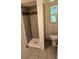 Small bathroom features a tiled shower and floor with a single window at 2350 / 2352 Garland St, Lakewood, CO 80215