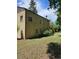 Beige two-story home featuring a backyard with a wooden staircase and lush greenery at 2350 / 2352 Garland St, Lakewood, CO 80215