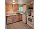 A compact kitchen features wood cabinets and modern appliances at 2350 / 2352 Garland St, Lakewood, CO 80215
