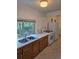 Bright kitchen with double sink, white appliances and ample natural light from the window at 2350 / 2352 Garland St, Lakewood, CO 80215