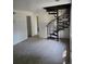 Carpeted living room with a unique spiral staircase to upper level at 2350 / 2352 Garland St, Lakewood, CO 80215