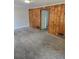 Spacious living room featuring wood paneling and neutral carpet, ready for personalization at 2350 / 2352 Garland St, Lakewood, CO 80215