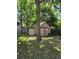Rustic shed in a shady backyard surrounded by mature trees, offering ample storage space at 2350 / 2352 Garland St, Lakewood, CO 80215