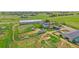 Expansive aerial view of horse property with large barn, paddocks, outbuildings, and rolling green pastures at 9255 N Delbert Rd, Parker, CO 80138