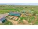 Drone shot of a horse property with a large barn, horse runs, riding arena, and a pasture area at 9255 N Delbert Rd, Parker, CO 80138