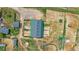 Aerial view of horse barn with surrounding paddocks and outdoor riding arena at 9255 N Delbert Rd, Parker, CO 80138
