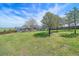 Expansive fenced backyard featuring a lush lawn and mature trees providing shade and privacy at 9255 N Delbert Rd, Parker, CO 80138