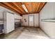 Unfinished basement area with exposed wood ceiling, work bench and white walls at 9255 N Delbert Rd, Parker, CO 80138