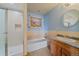 Bathroom featuring a tub, shower, vanity and framed seascape art at 9255 N Delbert Rd, Parker, CO 80138