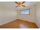 Clean bedroom with wood-look floors, ceiling fan, and a window with a clear view at 9255 N Delbert Rd, Parker, CO 80138