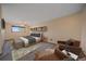 Cozy bedroom featuring soft carpet, a comfortable bed, and a stylish armchair with natural light at 9255 N Delbert Rd, Parker, CO 80138