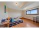A simple bedroom with wood floors, a window with natural light, and a bed on the floor at 9255 N Delbert Rd, Parker, CO 80138