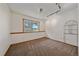 Clean and simple bedroom with neutral carpet, a large window and track lighting at 9255 N Delbert Rd, Parker, CO 80138