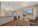 Dining room with wood floors, granite countertop island, stainless steel appliances, and a window view at 9255 N Delbert Rd, Parker, CO 80138