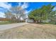 A beautiful house with a two-car garage and mature trees in the front yard and clear skies above at 9255 N Delbert Rd, Parker, CO 80138