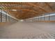 Large indoor riding arena with sand footing, wood framing and natural lighting at 9255 N Delbert Rd, Parker, CO 80138