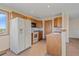 Bright kitchen with white appliances, wood cabinetry and tile floors at 9255 N Delbert Rd, Parker, CO 80138