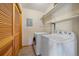 Laundry area featuring washer, dryer, storage shelves, and bifold door at 9255 N Delbert Rd, Parker, CO 80138