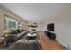 Bright living room featuring hardwood floors, stylish furniture, a large window, and modern decor at 9255 N Delbert Rd, Parker, CO 80138