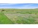 Rolling green fenced pastures, perfect for horses to graze, with beautiful blue skies above the property at 9255 N Delbert Rd, Parker, CO 80138