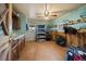 Spacious tack room featuring wood cabinets, sink, storage, and saddle racks at 9255 N Delbert Rd, Parker, CO 80138