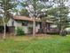 A view of the backyard with mature trees and a wooden deck at 5274 W Rowland Pl, Littleton, CO 80128