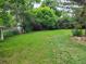 Lush backyard featuring a shed surrounded by mature trees, shrubs, and a well-maintained lawn at 5274 W Rowland Pl, Littleton, CO 80128
