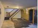 Spacious basement featuring stairs and a doorway at 5274 W Rowland Pl, Littleton, CO 80128