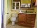 Bathroom with single sink vanity, medicine cabinet, and standard toilet at 5274 W Rowland Pl, Littleton, CO 80128