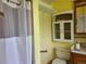 Bathroom features a standard toilet, shower with curtain, and medicine cabinet at 5274 W Rowland Pl, Littleton, CO 80128