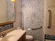 Cozy bathroom featuring blue accents, a functional toilet, sink and practical accessibility grab bars at 5274 W Rowland Pl, Littleton, CO 80128