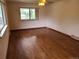 An empty bedroom with hardwood flooring and natural lighting at 5274 W Rowland Pl, Littleton, CO 80128