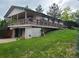 Side view showing raised home with a large deck at 5274 W Rowland Pl, Littleton, CO 80128