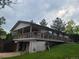 Side view showing this raised home with a large deck and basement garage at 5274 W Rowland Pl, Littleton, CO 80128