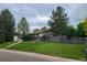 Inviting view of a home with mature landscaping and trees, set back from the street for privacy at 5274 W Rowland Pl, Littleton, CO 80128