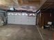 Clean garage interior showcasing a large white door, mechanical components, and simple furnishings at 5274 W Rowland Pl, Littleton, CO 80128