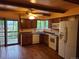 Kitchen with wooden cabinets, white appliances, and hardwood floors at 5274 W Rowland Pl, Littleton, CO 80128