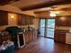 Kitchen with wooden cabinets, white appliances, and hardwood floors at 5274 W Rowland Pl, Littleton, CO 80128