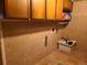 Laundry room with cabinets, sink, tiled backsplash, and hookups at 5274 W Rowland Pl, Littleton, CO 80128