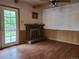 A living room with hardwood flooring, brick fireplace and access to the backyard at 5274 W Rowland Pl, Littleton, CO 80128