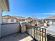 View from the balcony showcases the neighborhood's charming architecture under a bright blue sky at 6725 S Winnipeg Cir # 106, Aurora, CO 80016