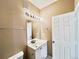 Bright bathroom features a single sink vanity, a mirror and a modern vanity light at 6725 S Winnipeg Cir # 106, Aurora, CO 80016
