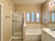 Bathroom features a double vanity, tub, and glass-enclosed shower at 6725 S Winnipeg Cir # 106, Aurora, CO 80016