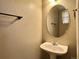 The bathroom is complete with an oval mirror, sink and fixtures at 6725 S Winnipeg Cir # 106, Aurora, CO 80016